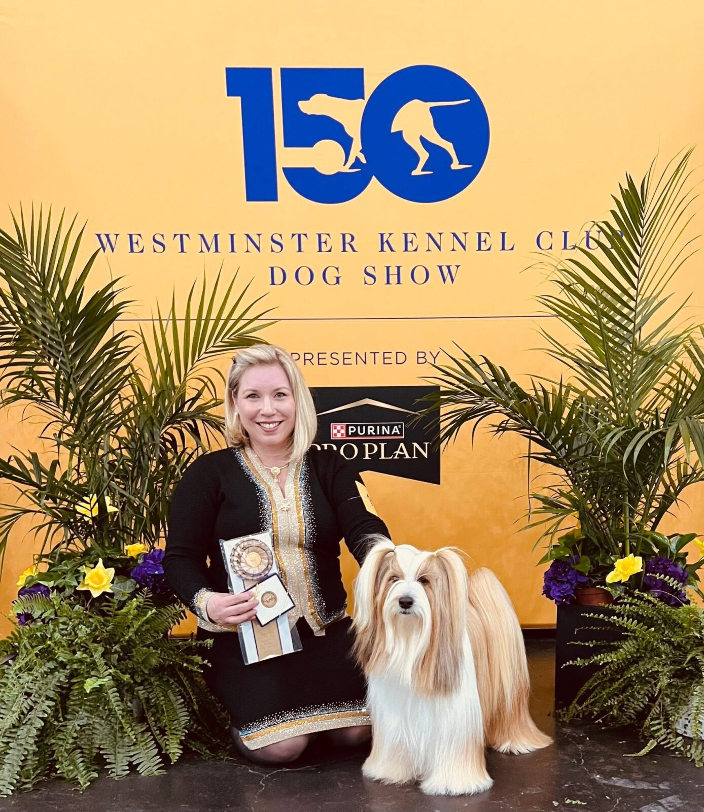 Woman with award-winning dog at Westminster Kennel Club Dog Show.